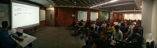 Photo of a meetup showing a speaker delivering a session.